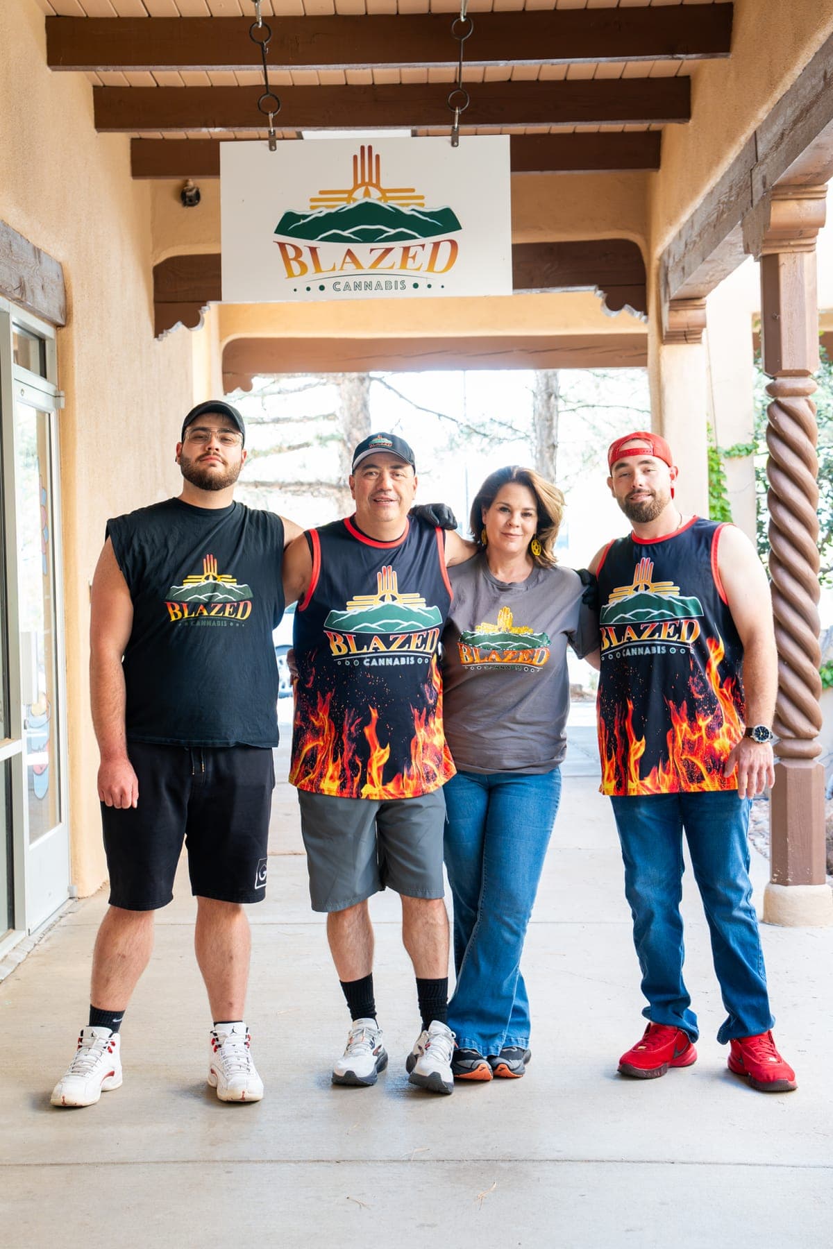 The Blazed family, James, Jennifer, Dominic, and Anthony, arm in arm under the shop sign