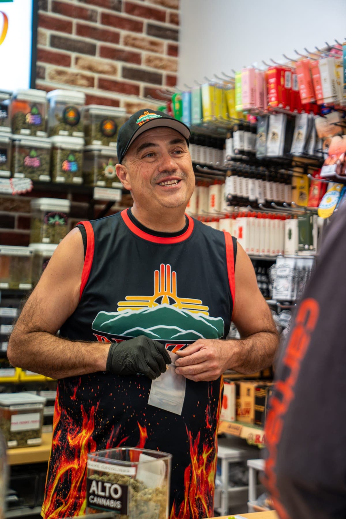 James, one of the owners, smiling behind the deli counter