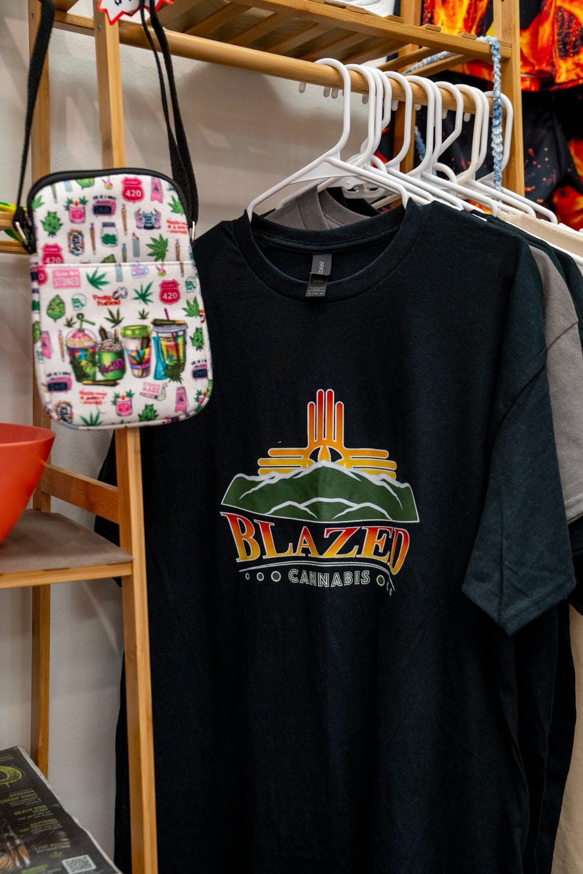 A Blazed Cannabis t-shirt hanging on the merch rack
