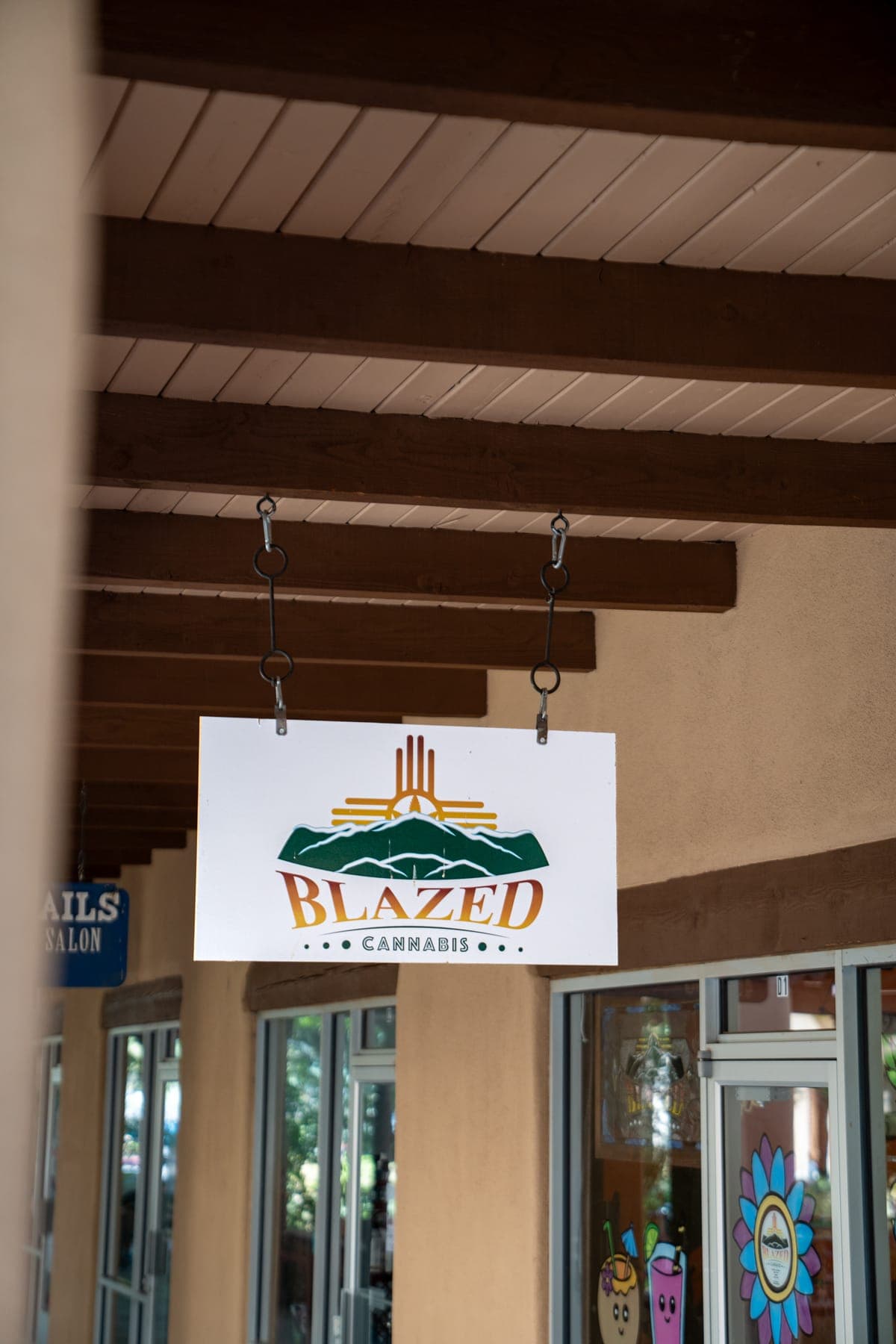 The Blazed Cannabis sign under the portal, a carved wooden post beside it