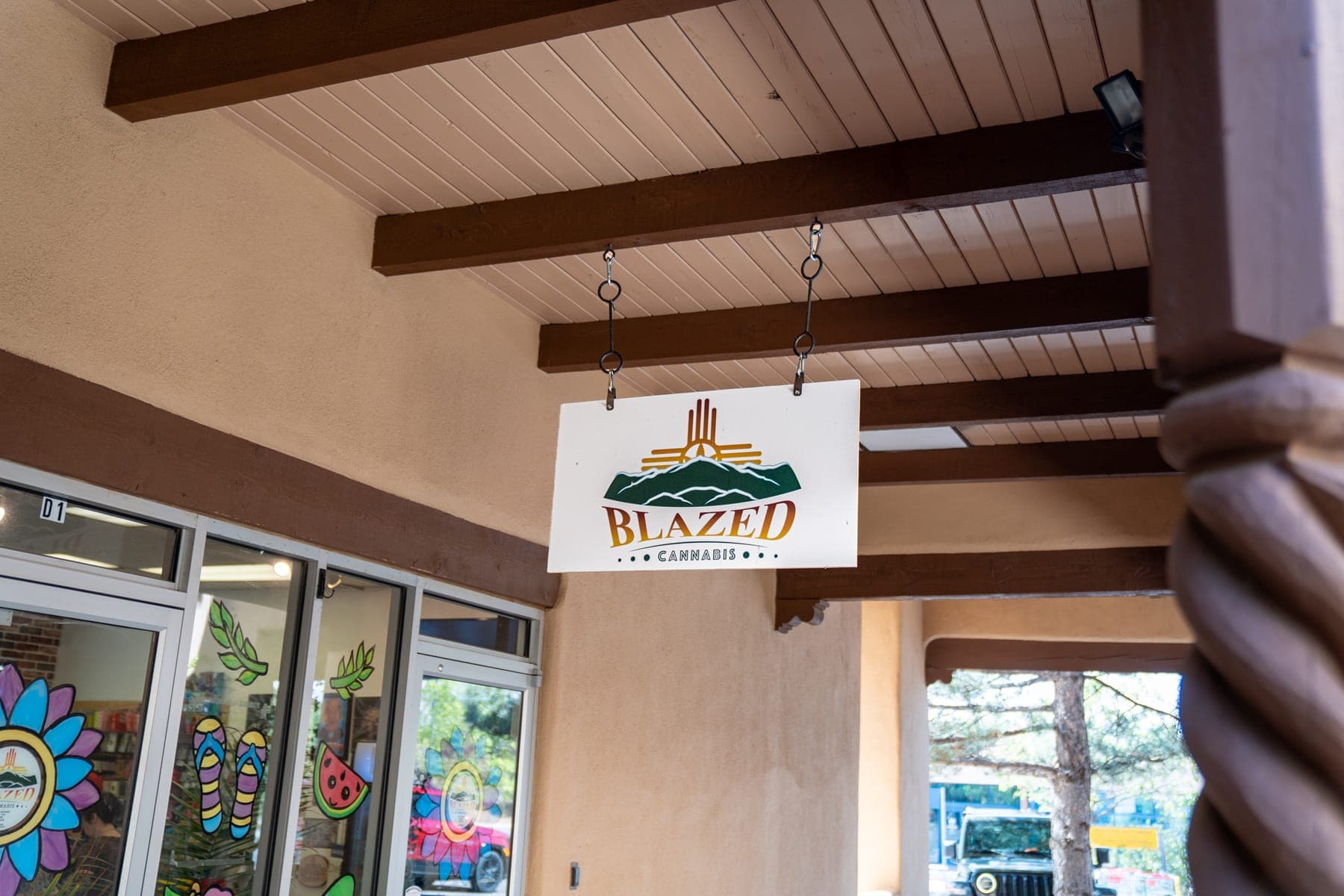 The Blazed Cannabis sign hanging from wooden vigas above the shop entrance