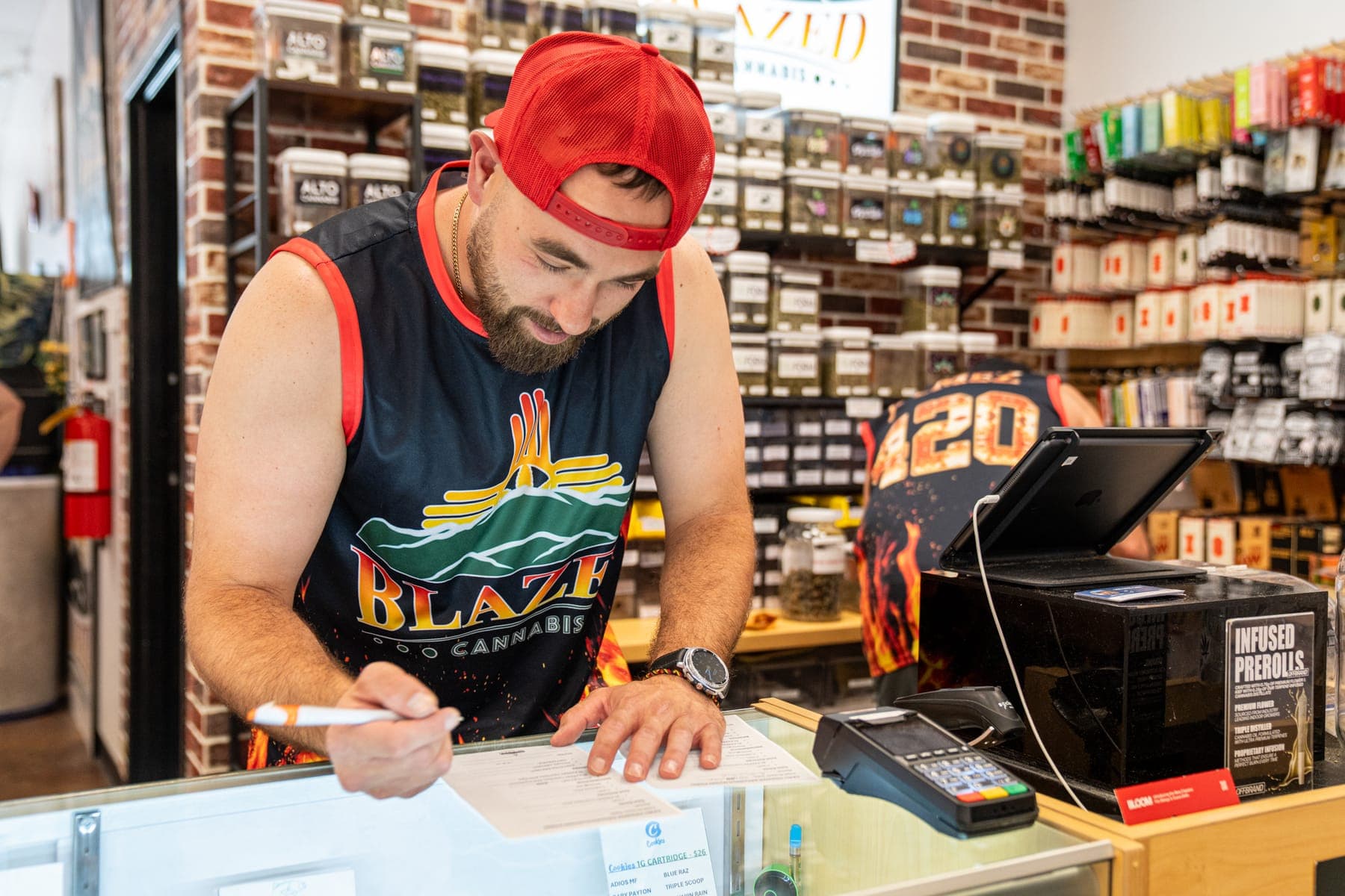 One of the sons writing up an order at the counter